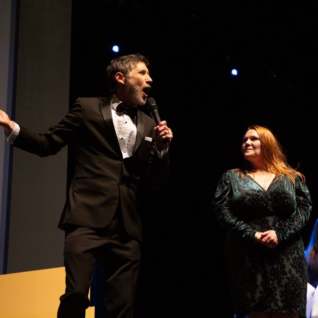 professional-emcee-corporate-gala-stage-Coast Capitol Roger on stage with audience member