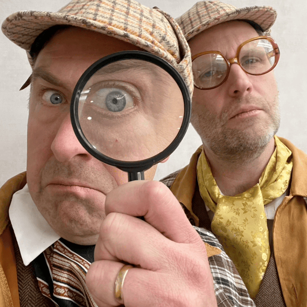 2-detectives-with-magnifying-glass-corporate team building, keynote speakers and emcees, Vancouver