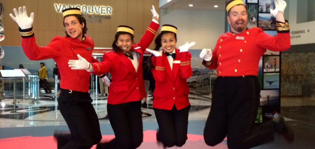 Bellhops jumping with excitement at corporate event