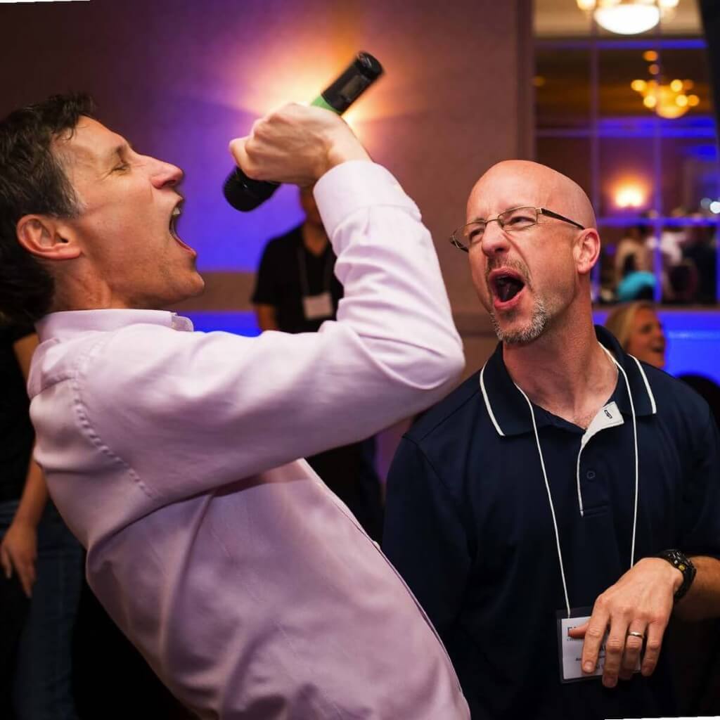 Game show host with microphone + crowd