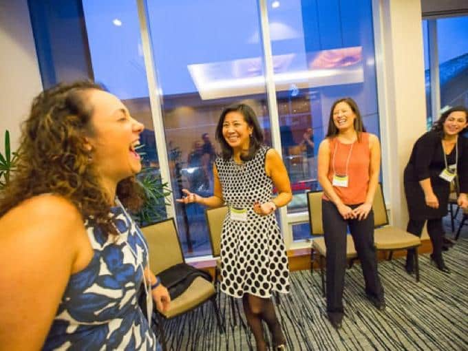 Team laughing together at a conference