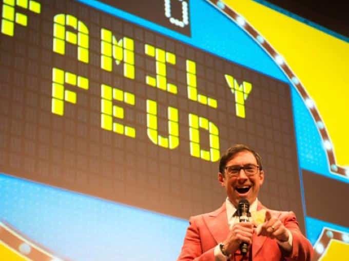 Host presenting the Family Friendly Feud game board at an Engagement Unlimited corporate team building event