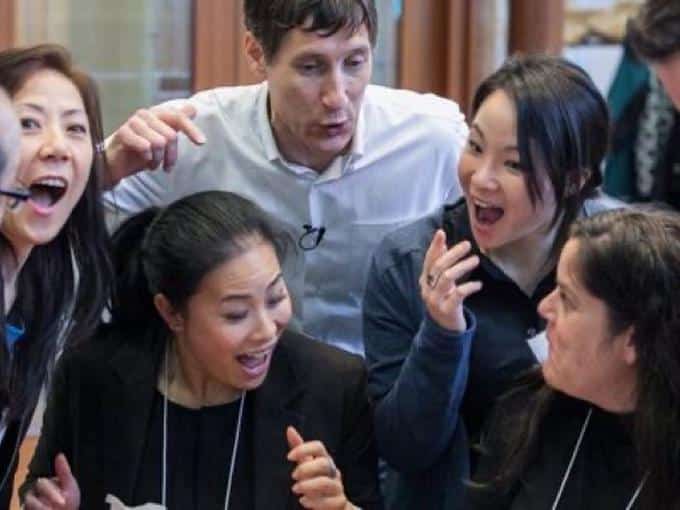 Small group in animated discussion during a retreat