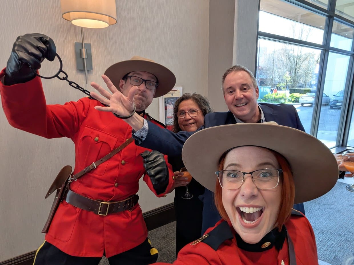 Roving Mounties Stefano and Barbara greeting guests with the handcuffs out at a corporate event