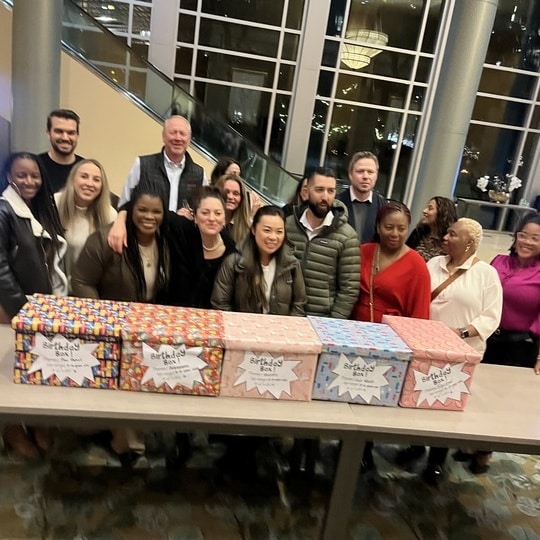 A group poses with their finished Birthday Boxes