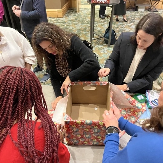 An employee wraps a gift for a Birthday Box