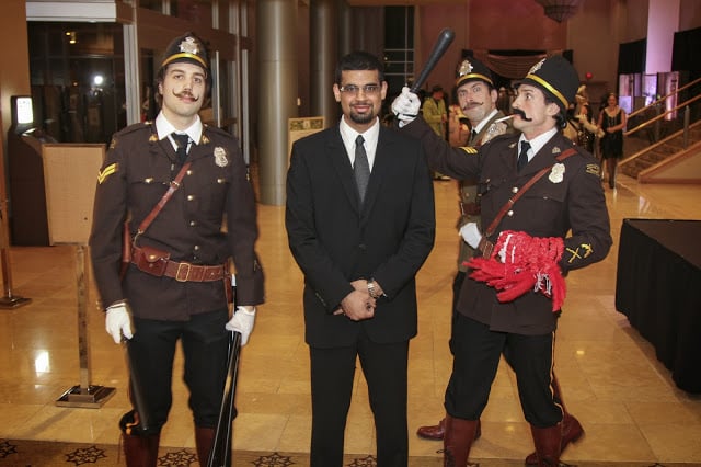 A themed 'Bobbie Cop' costumed performer works the room