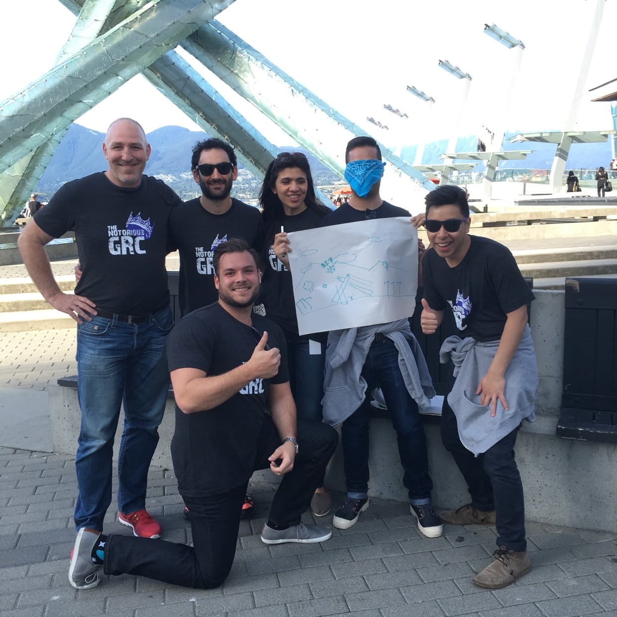 A team pauses at the street artists near Jack Poole Plaza