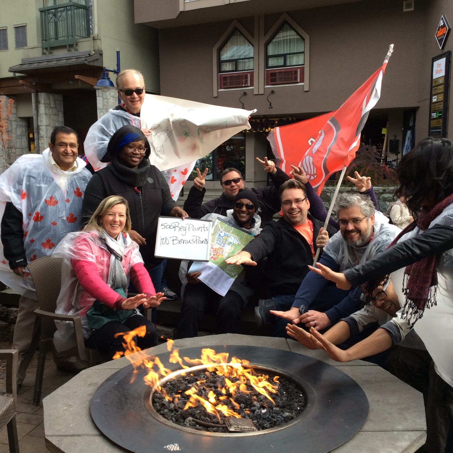 A team gathers around a mock campfire stop in Whistler