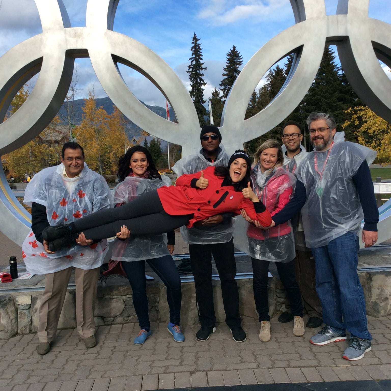 A team celebrates at the Olympic Rings checkpoint