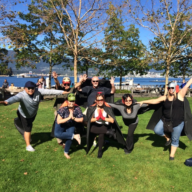 A team tries a yoga-pose challenge at Coal Harbour