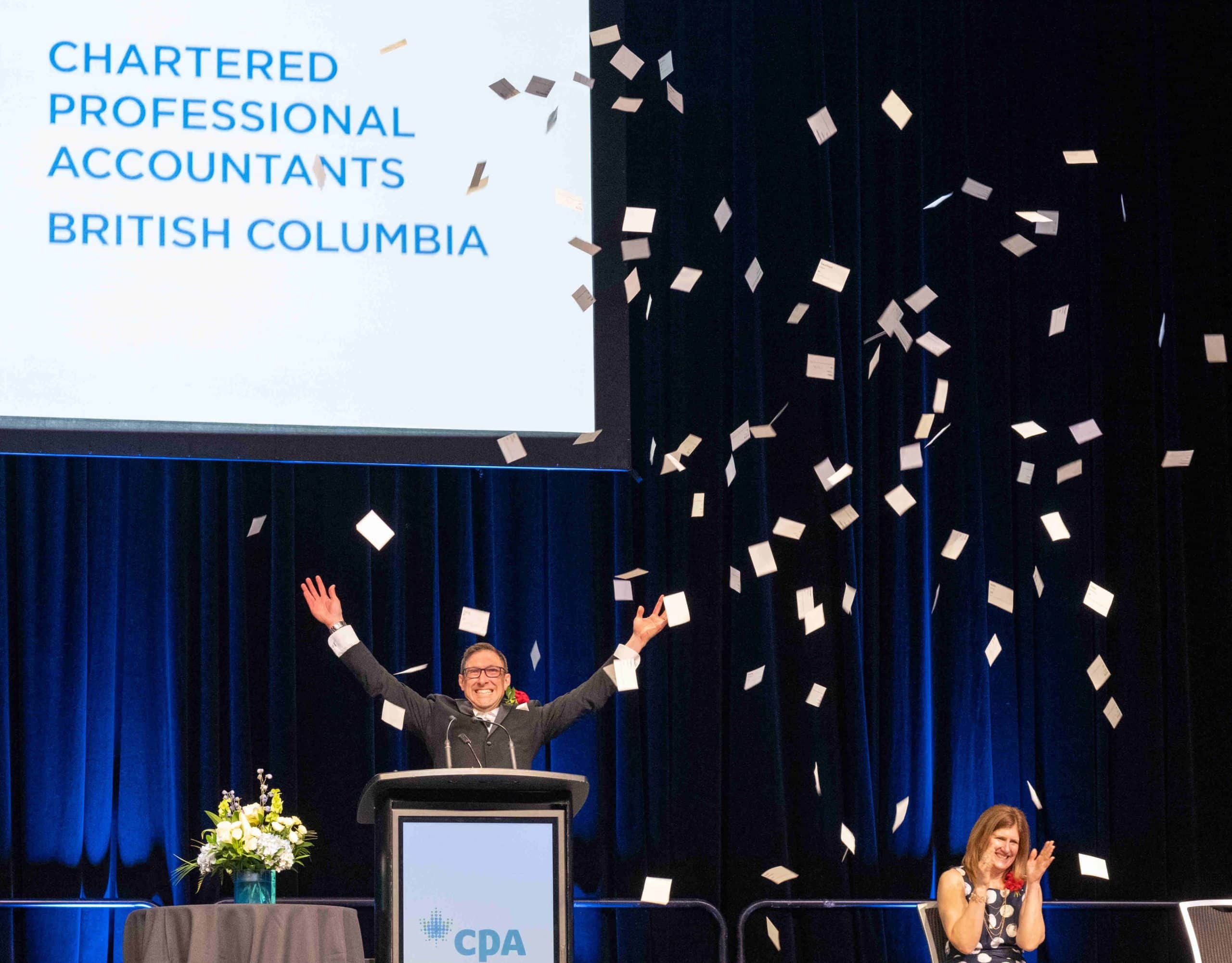 Stefano throws confetti into the air at the CPABC Convocation