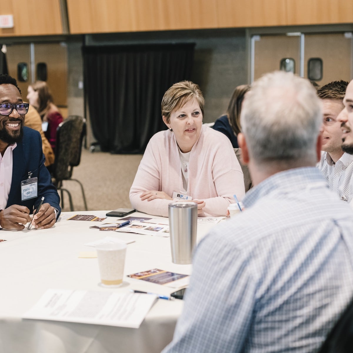 A table group works through a discussion exercise at a conference