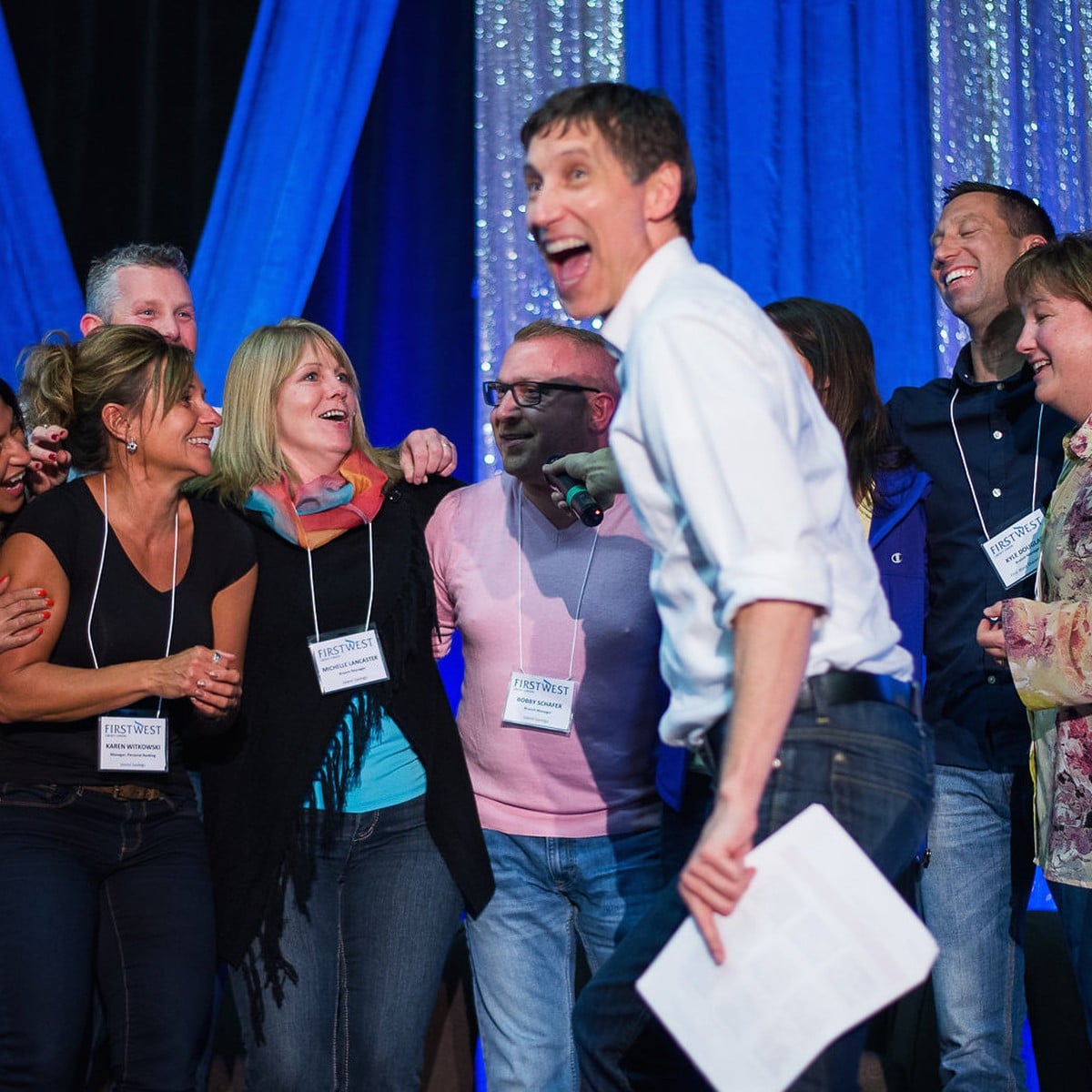 Roger brings guests on stage during a keynote at FirstWest