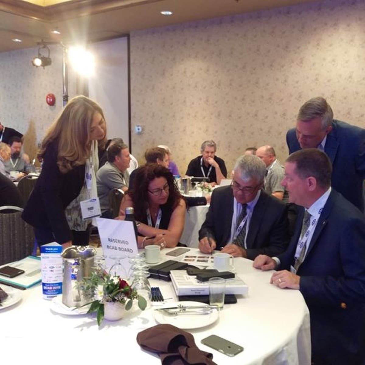 The BCAB board table mid-discussion at a conference