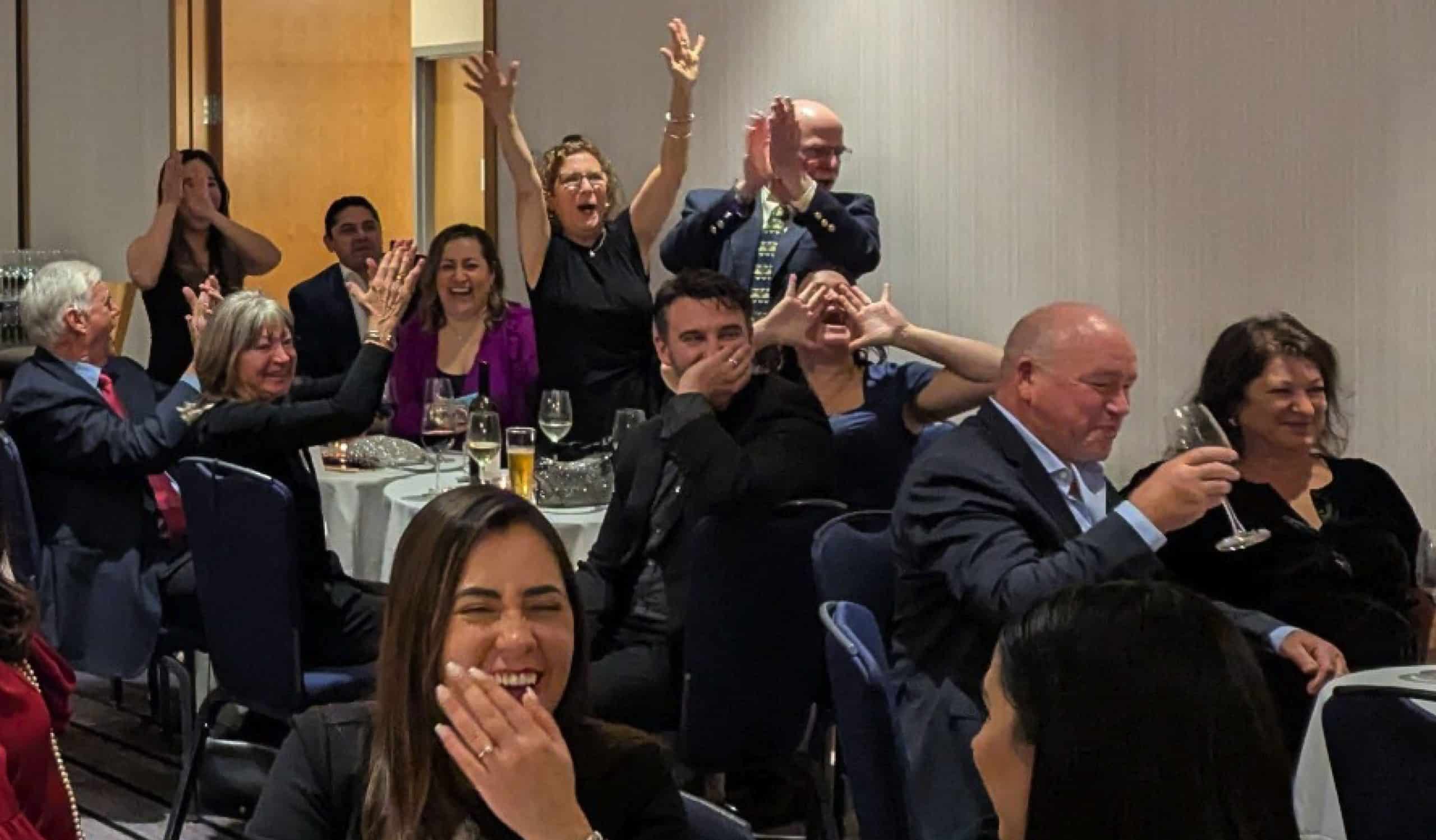 A team celebrates a correct answer during POP Trivia