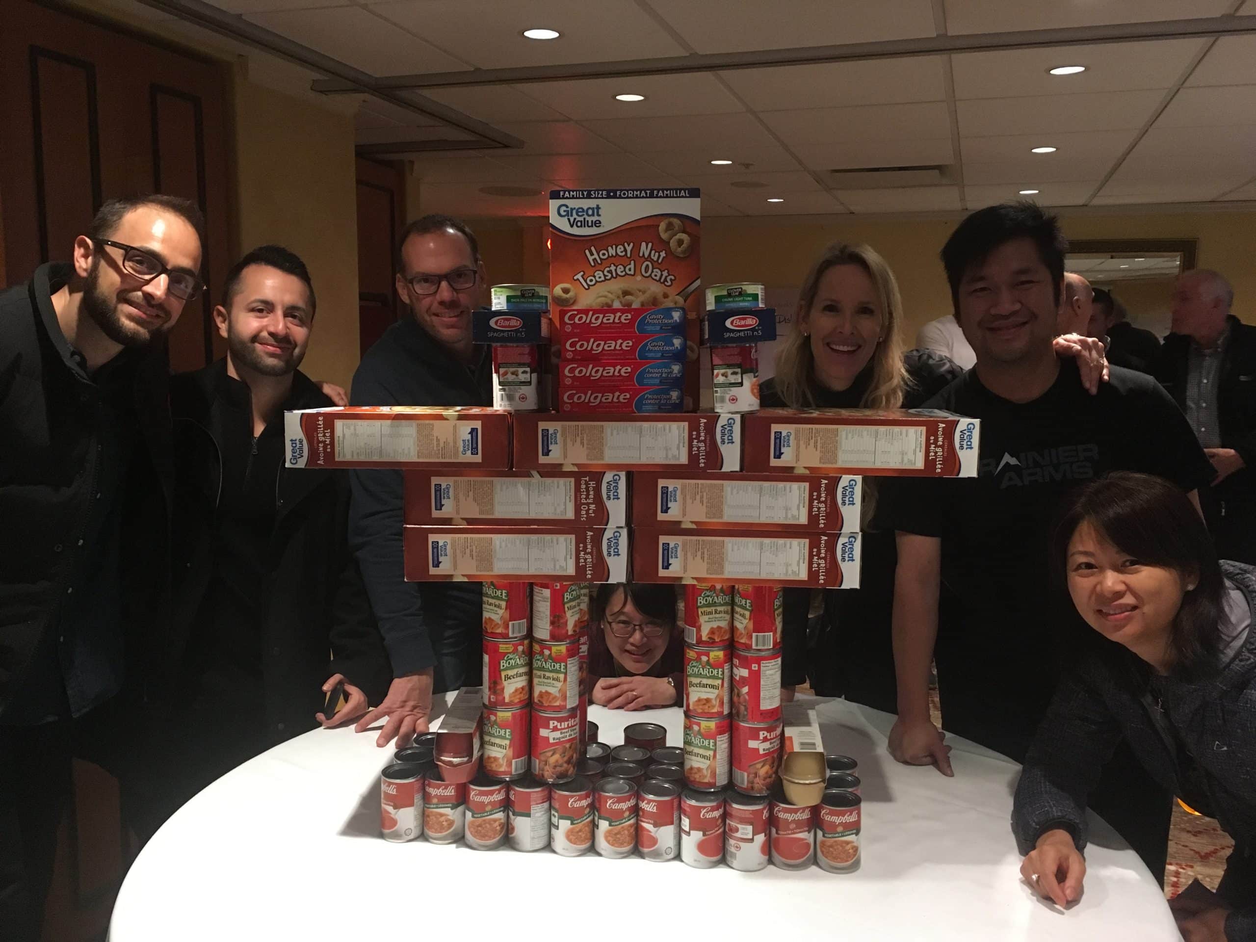 A team packs boxes of food for the Food for Families give-back