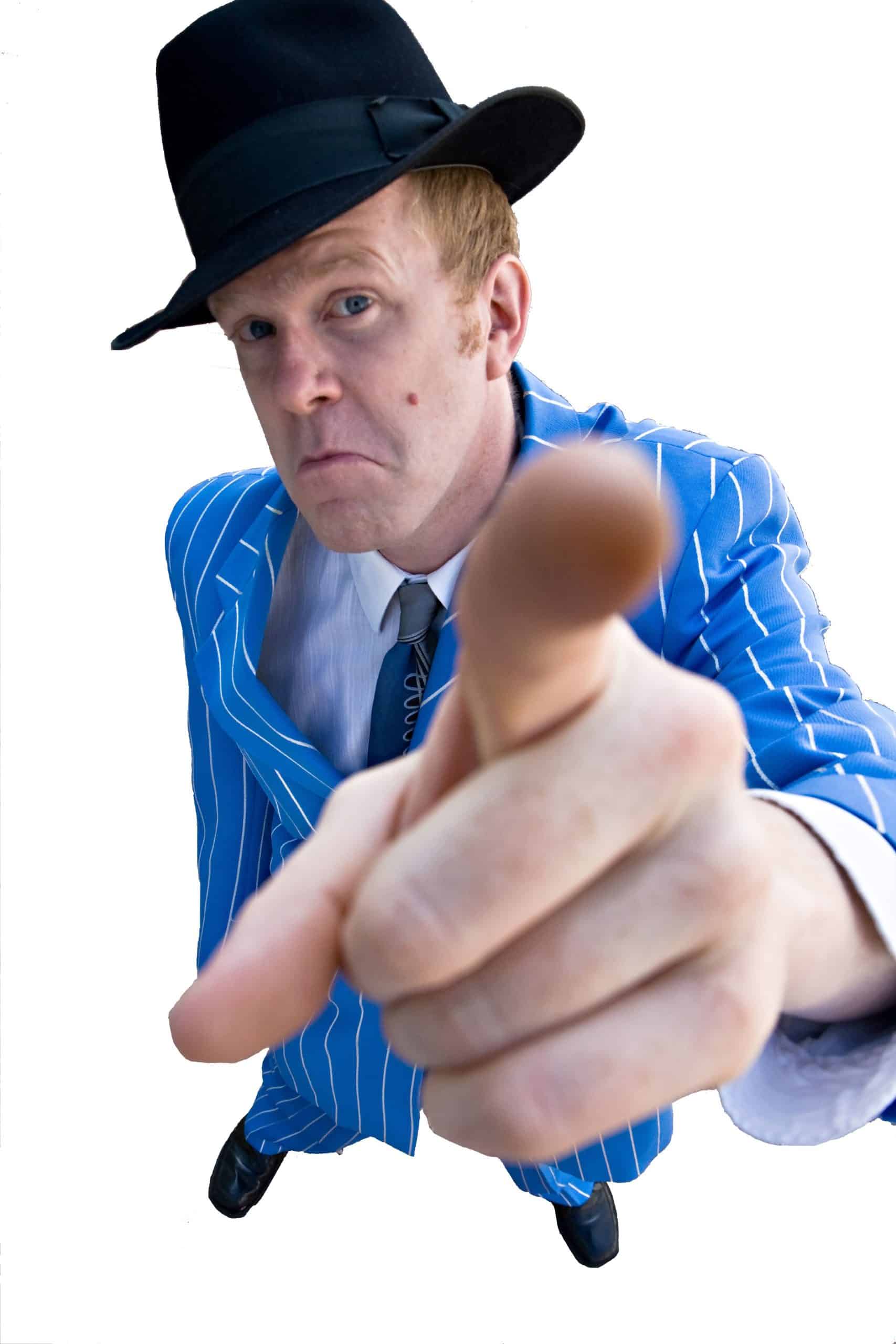 A performer in character pointing accusingly during the mystery