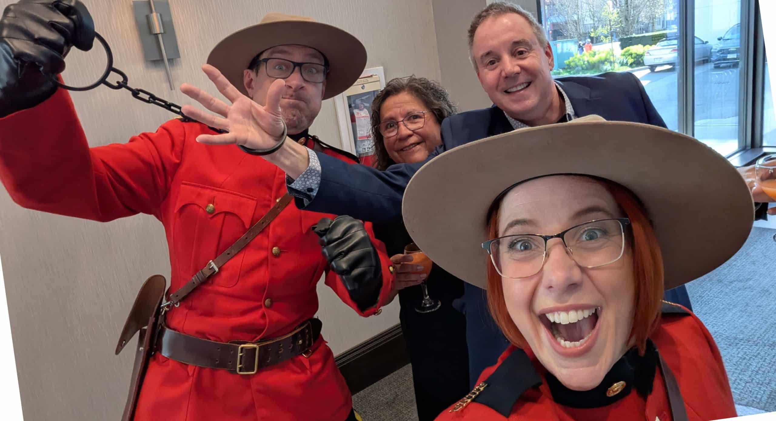 Costumed Mountie characters pose with guests at a corporate event