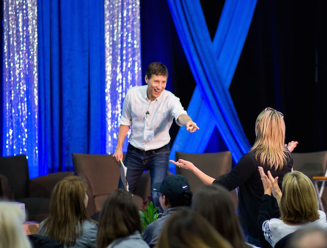 Roger points to an audience volunteer during an interactive moment of his keynote.