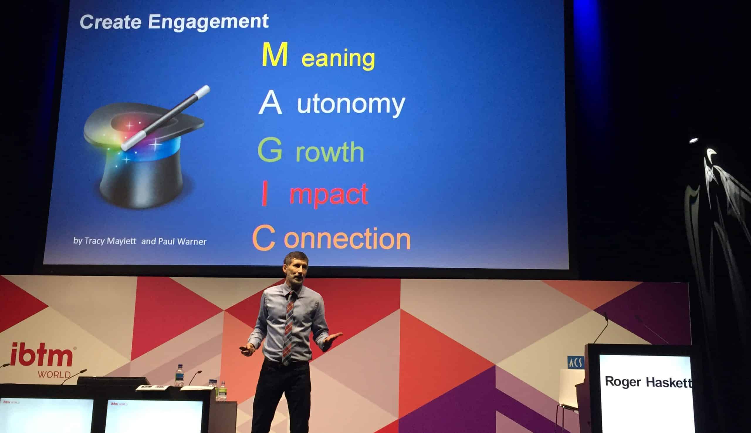 Roger speaks on stage at IBTM World