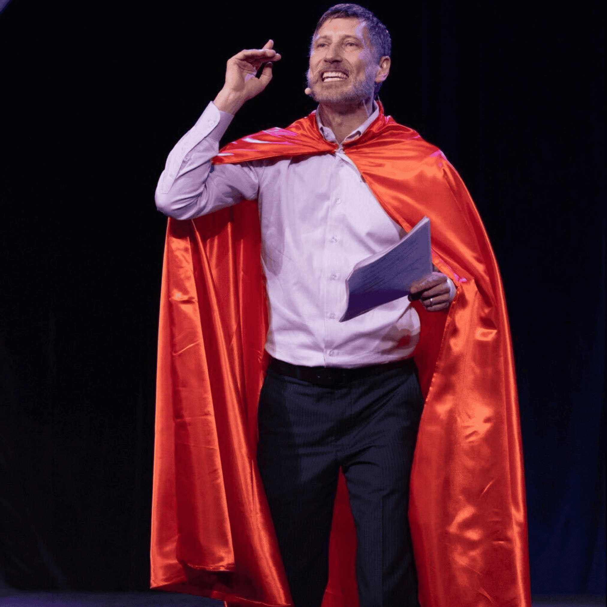Roger performs a caped entrance as emcee