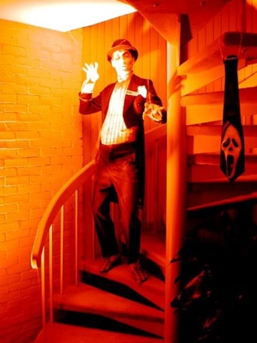 A scary Halloween-themed greeter character on the stairs