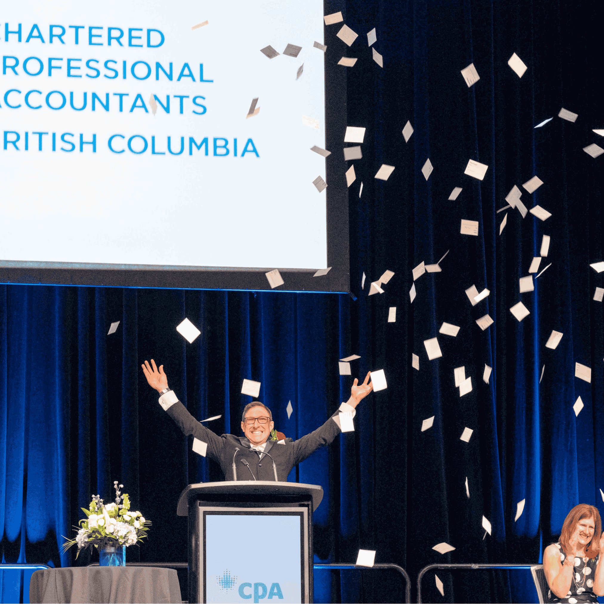 Stefano throws cards into the air as emcee