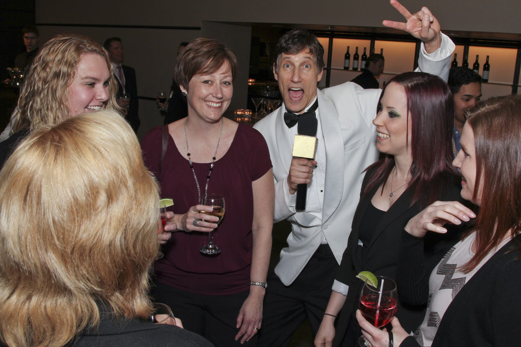 Roger, mic in hand, works the room during a cocktail-hour crowd interview