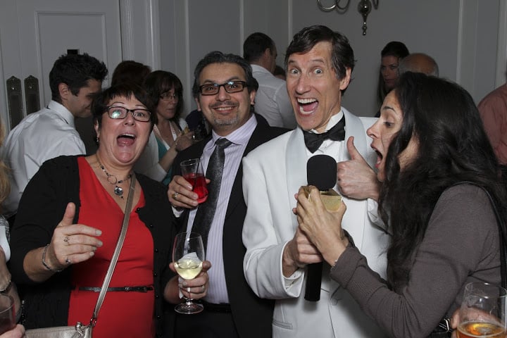 Roger interviews laughing guests during the cocktail-hour reception at the Walmart Saturday gala