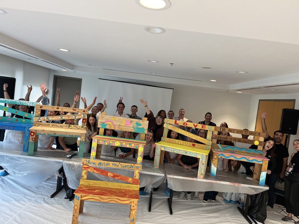 A full group poses with a newly built Buddy Bench